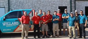 A group of Willard employees stand in front of a company truck.
