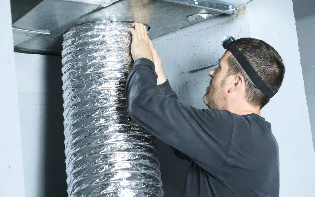 Technician servicing air ducts.