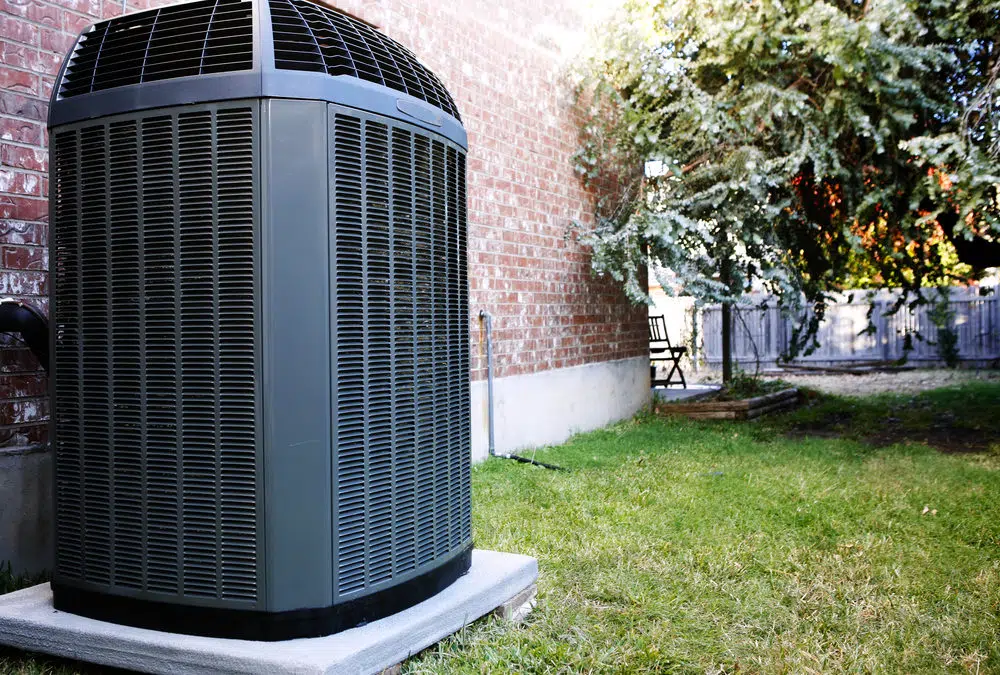  Outdoor AC unit alongside a brick home. 