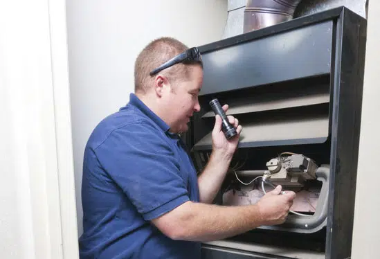 Technician inspecting a furnace