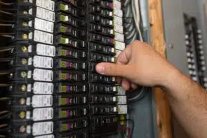 Electrician checking breaker panel